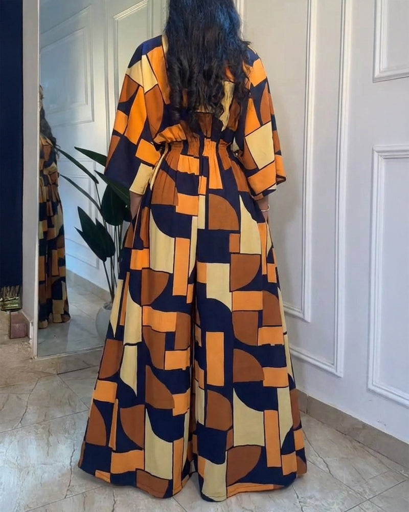 Colorblock-Jumpsuit mit geometrischem Druck, V-Ausschnitt, Fledermausärmeln, geraffter Taille und weitem Bein