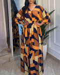 Colorblock-Jumpsuit mit geometrischem Druck, V-Ausschnitt, Fledermausärmeln, geraffter Taille und weitem Bein