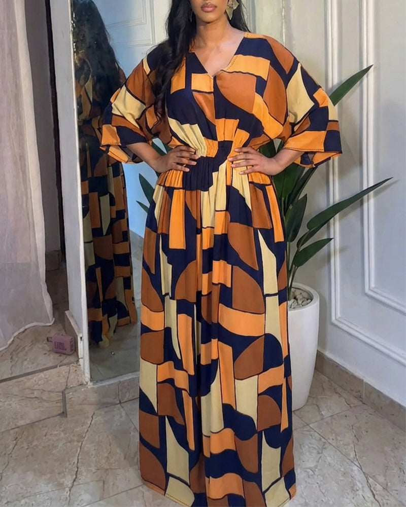 Colorblock-Jumpsuit mit geometrischem Druck, V-Ausschnitt, Fledermausärmeln, geraffter Taille und weitem Bein