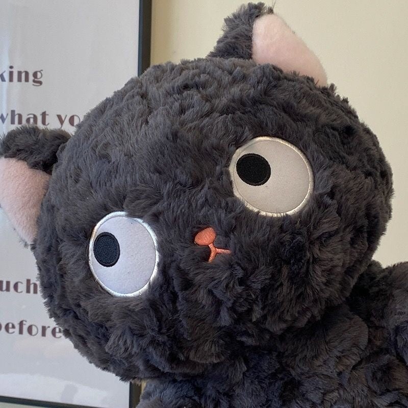 Jiji the Fluffy Black Cat Plushie Laying Down