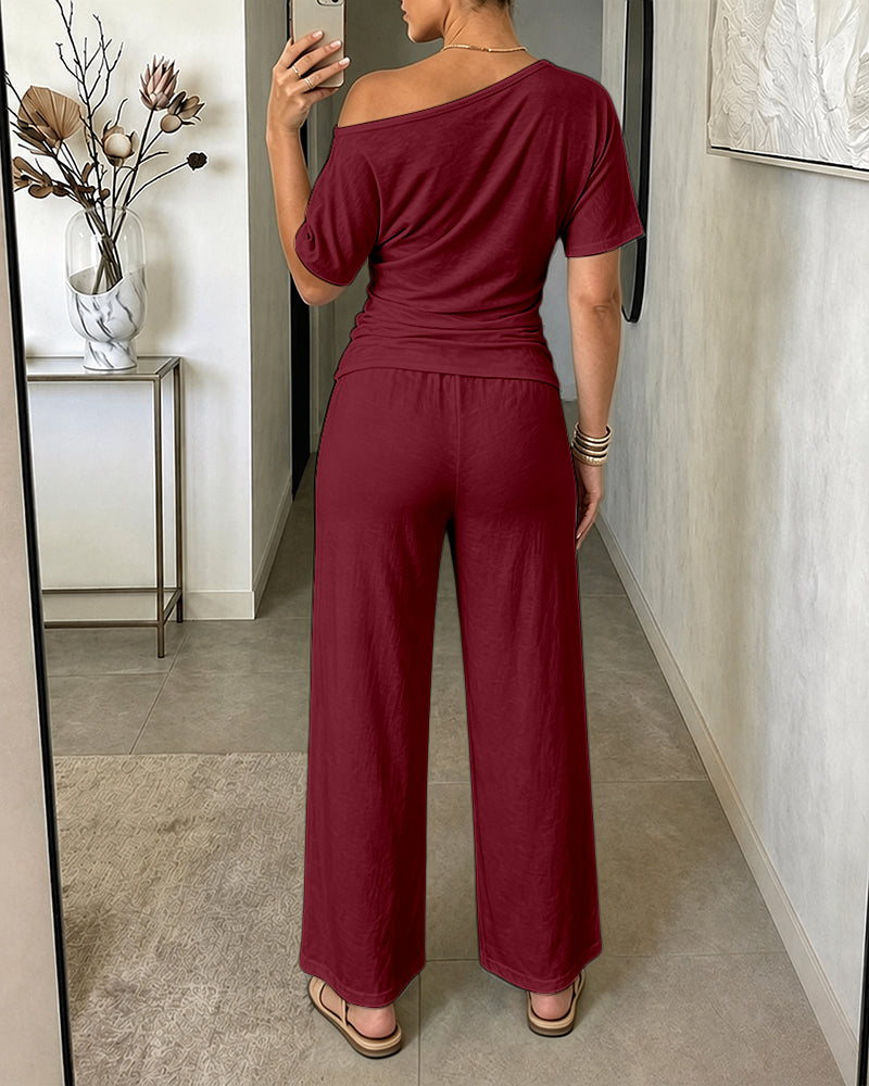 Damen 2-teiliges Set mit schrägem Ausschnitt, gerafftem Oberteil mit Bindegürtel und kurzärmeligem Shirt sowie Hose mit weitem Bein und hoher Taille